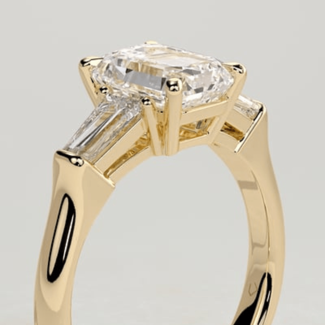 3 CT Emerald Cut Moissanite 4 Claw Trilogy with Tapered Baguette Side Stones Engagement Ring - Kazara Diam