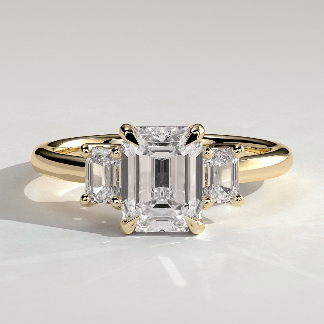 4CT Emerald 4 Claw Trilogy Engagement Ring with Emerald Side Stones - Kazara Diam