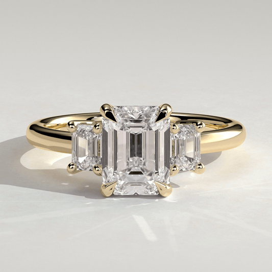 4CT Emerald 4 Claw Trilogy Engagement Ring with Emerald Side Stones - Kazara Diam